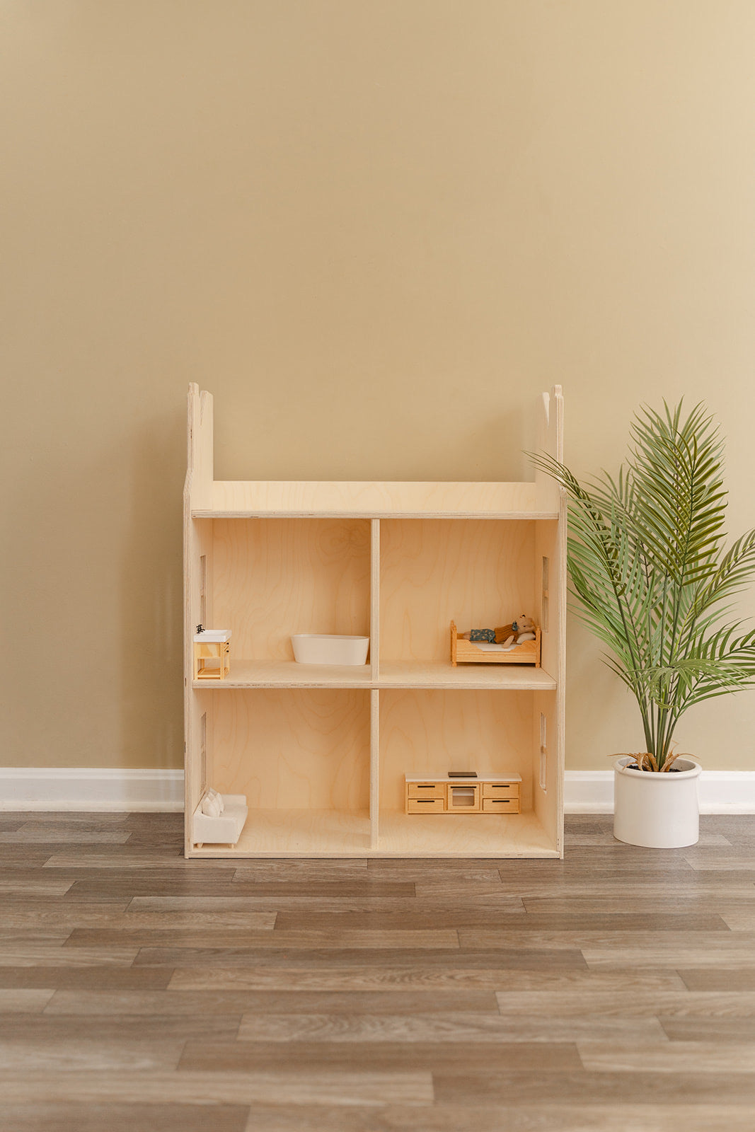 wooden doll house with four rooms, two chimneys and a minimalistic aesthetic