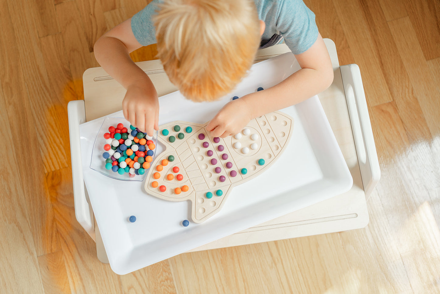 Spaceship shaped puzzle with wooden balls