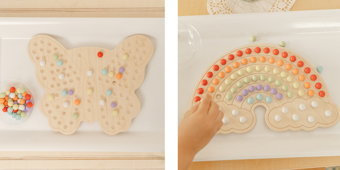 Two products photos of wooden activity boards. One is a wooden butterful with colorfull balls placed on the butterfly in a design. Next to wooden butterfly is a wooden rainbow with colorful balls placed in ROYGBIV order. The Activity boards are perfect for preschool, primary, and early elementary students 