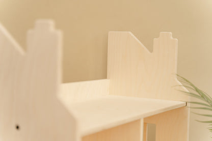 Close-up of wooden dollhouse customizable rooftop level with dual decorative chimneys and open-concept patio space, 3-story pretend play house featuring flexible top floor that can become rooftop garden attic hideaway or outdoor entertaining area, life-size dollhouse allowing children to design and reimagine spaces encouraging architectural thinking and creative planning for ages 3 and up