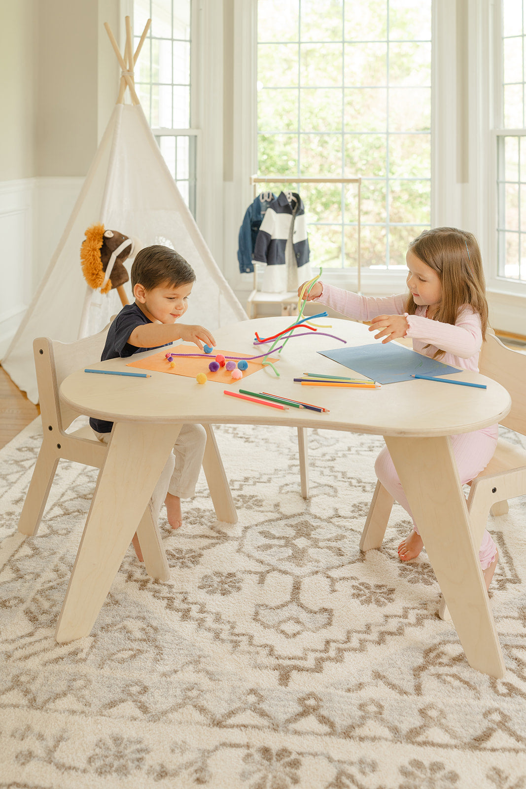 Two children sharing the Grow-With-Me kids table, each with their own side