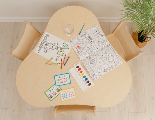 Overhead view of the Blueberry and Third Grow With Me solid wood kids table and three chairs, made in the USA from Baltic birch, with coloring pages, crayons, watercolors and number cards