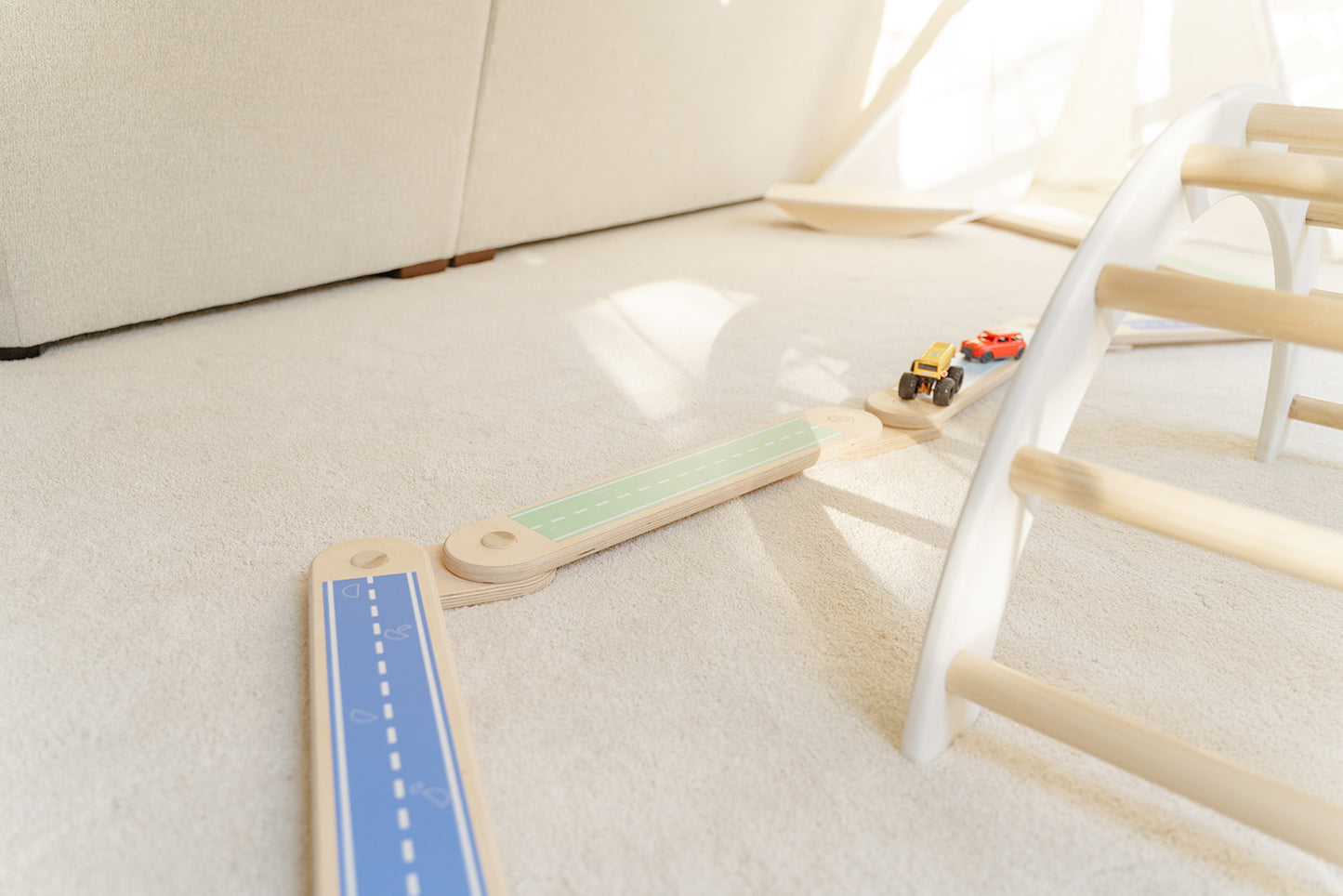 Balance beam with road stickers and trucks