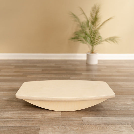 Wooden balance board for kids that is low to the ground and has rounded edges