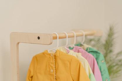 Blueberry and Third children's clothing display styled in toddler bedroom, low accessible rack empowers independent dressing and organizational skills