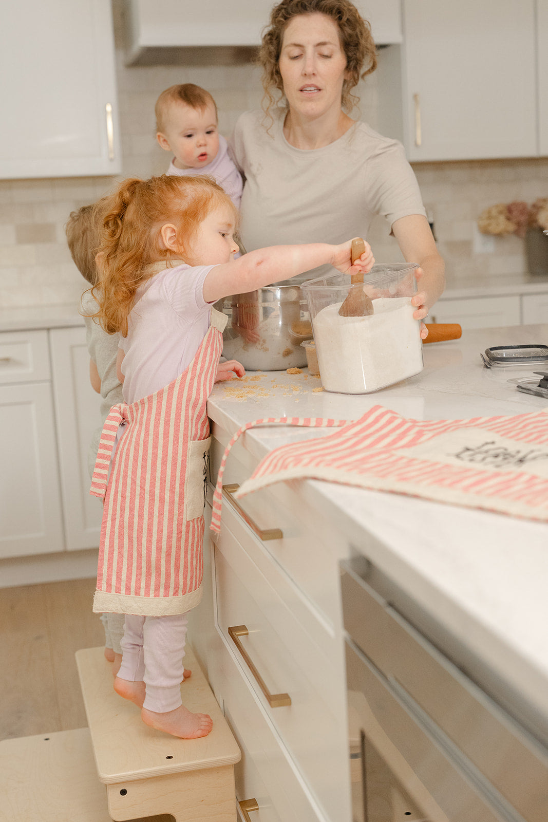 Toddler using Blueberry and Third Double Stool at bathroom sink — low profile, Montessori independence