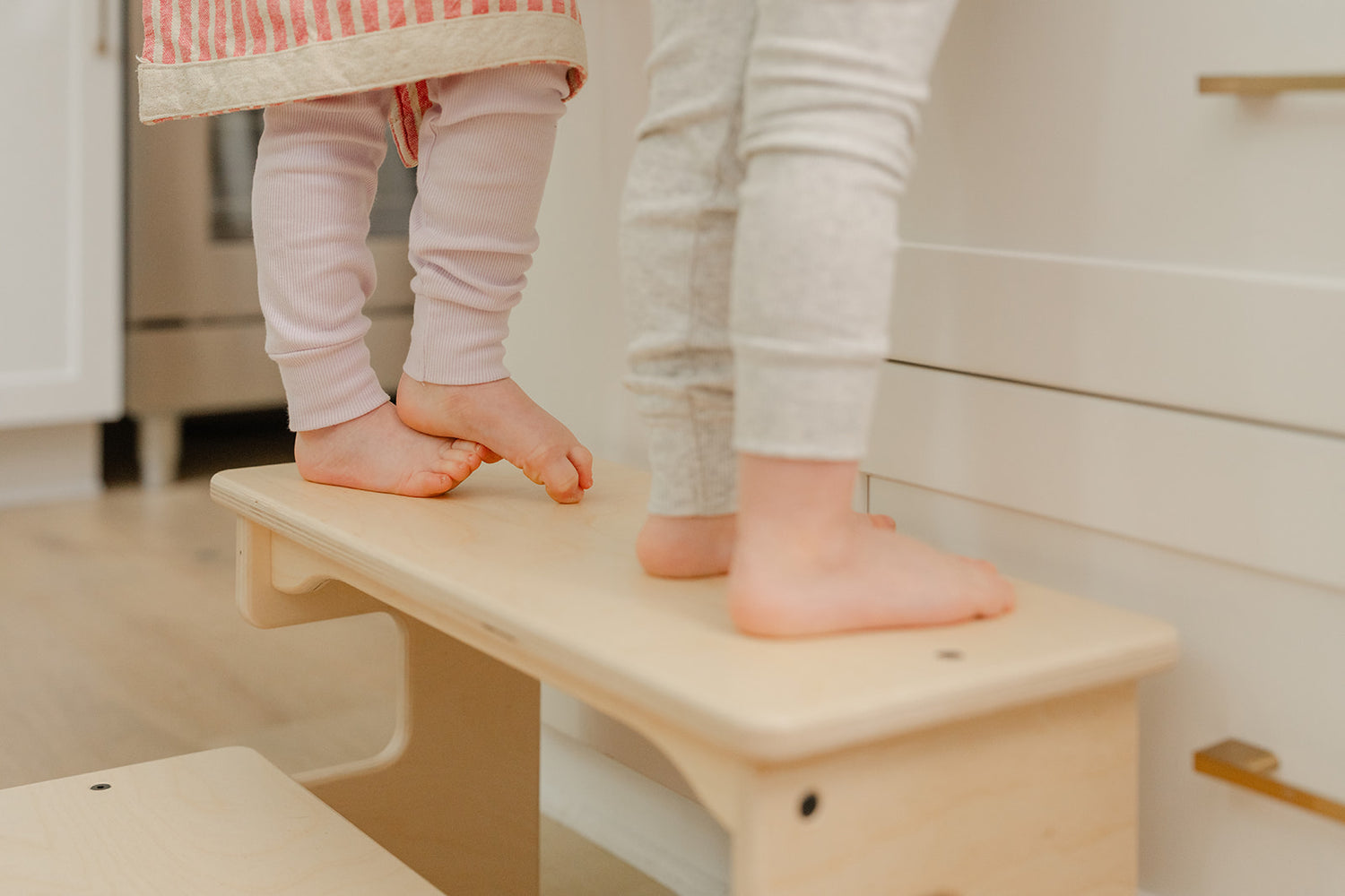 Blueberry and Third 2-step footstool in natural Baltic birch, Montessori kitchen stool that builds toddler independence at counter and sink height daily