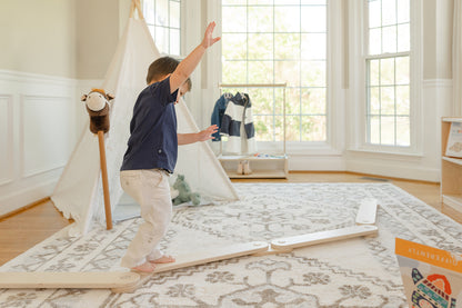 Blueberry and Third kids balance beam configured as a toddler obstacle course, four connected beams on a soft playmat, handcrafted in Ohio