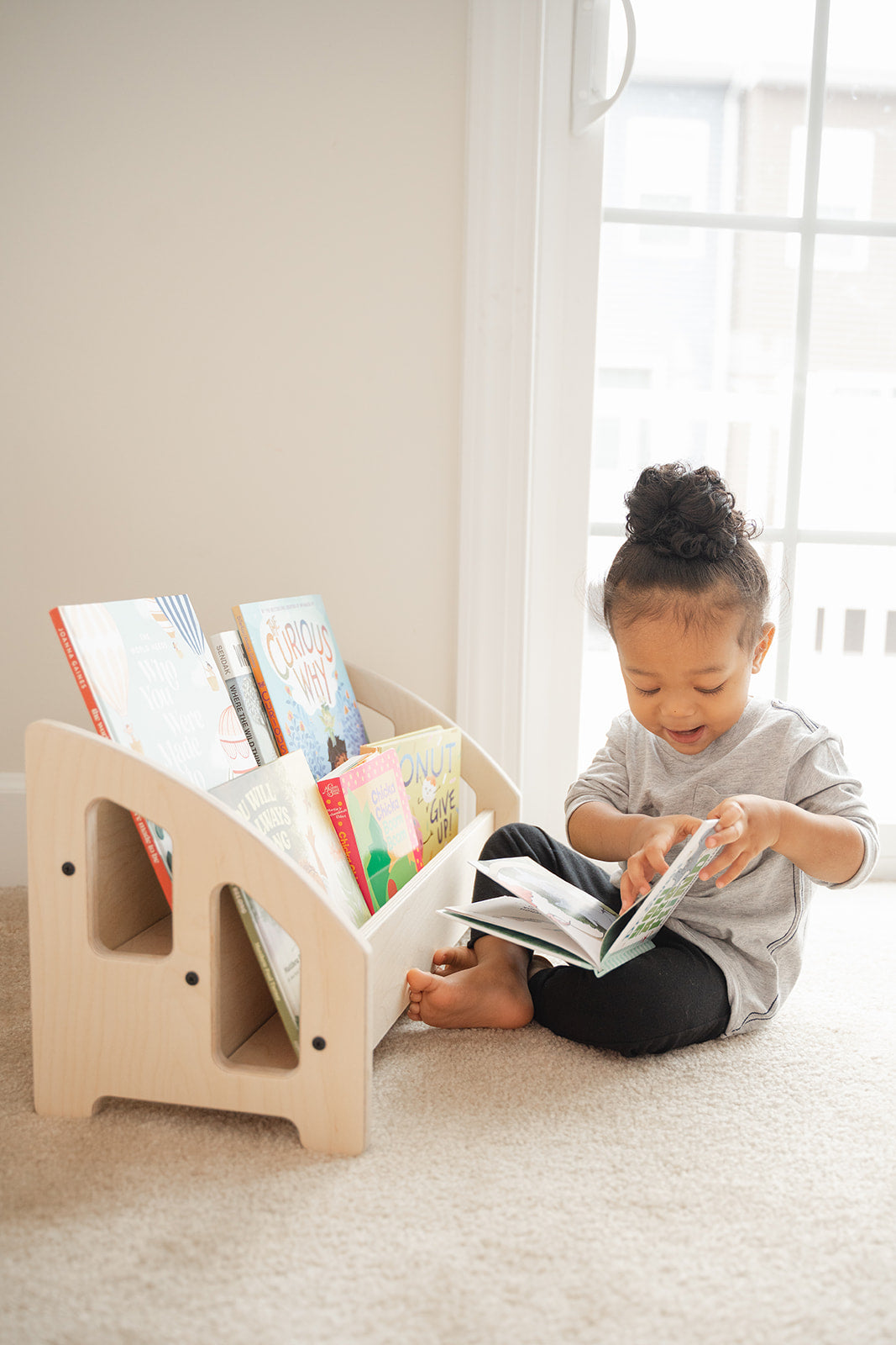Blueberry and Third toddler bookshelf with forward-facing shelves displaying book covers at child height, ideal nursery bookcase for ages 6 months and up