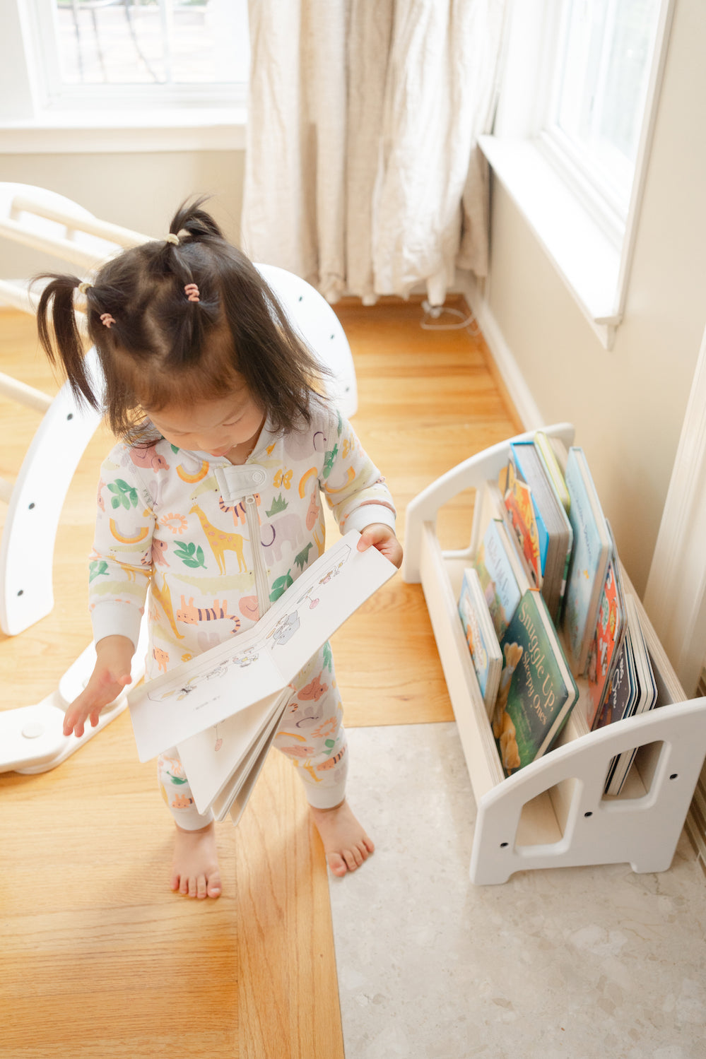 A bookshelf on hardwood floors that's easy to reach for toddlers