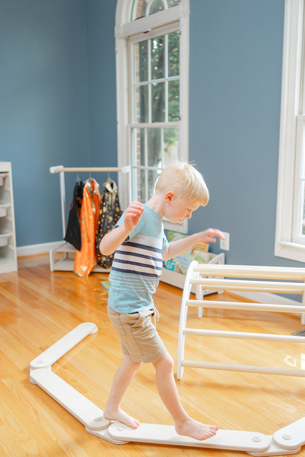 Modular wooden balance beam for kids showing four connected beams in straight configuration for toddler obstacle course and gross motor skill development ages 12 months to 8 years