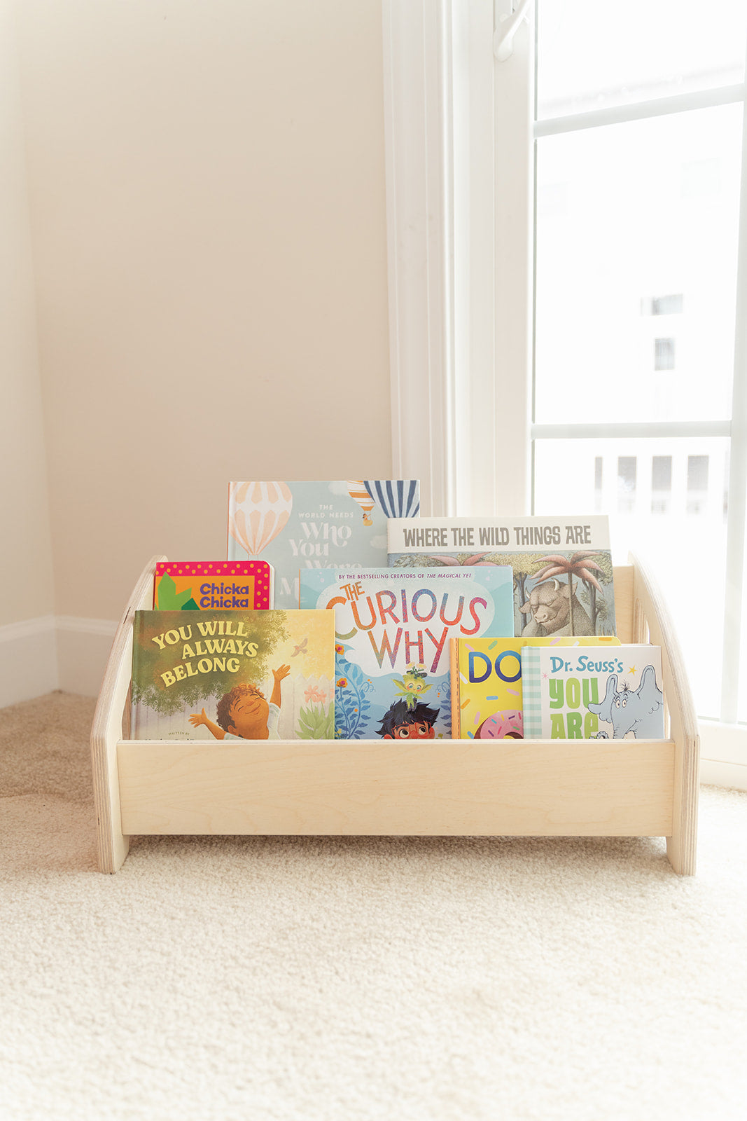 Two-tiered bookshelf beautifully styled in modern nursery showing how front-facing book display shelf complements simple home decor while serving practical function promoting early literacy and reading independence, wooden kids bookshelf featuring natural Birch hardwood finish with water-based coating blending seamlessly into neutral color palette of minimalist playroom or bedroom creating cohesive aesthetic design that parents and children both love, low-profile children's furniture fitting discreetly