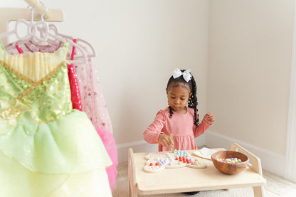 Preschooler sorting rainbow-colored wooden balls by color on butterfly Montessori activity board learning color recognition and categorization skills. Educational peg board toy for ages 3-6 promoting early math concepts through hands-on sorting matching and organizing activities. Wooden sensory toy encouraging logical thinking decision-making and cognitive development through open-ended color sorting games and creative play scenarios in screen-free learning environment.