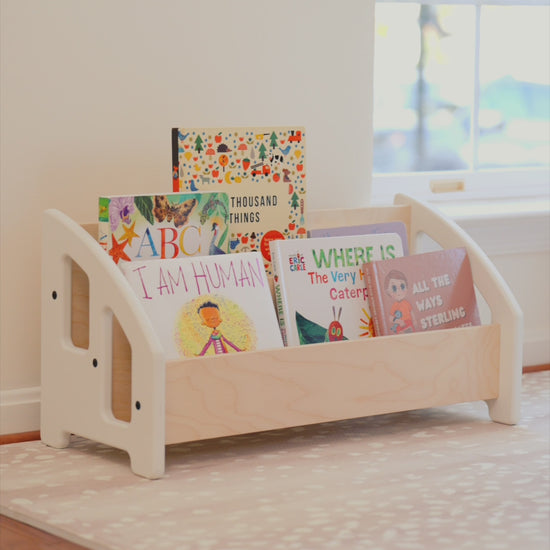 Bookshelf that is low to ground and easily accessible for young children.