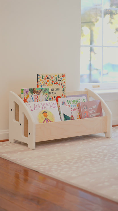 Bookshelf that is low to ground and easily accessible for young children.