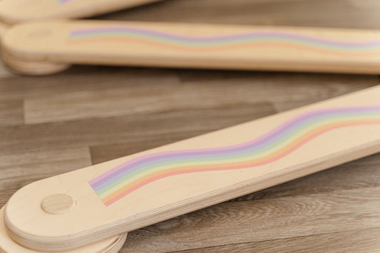 Rainbow sticker decals that can be placed on top of a balance beam to transform it