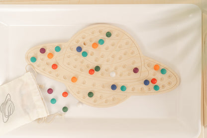 Beautiful Saturn-themed activity board with engraved planetary ring design inspiring space science learning and astronomy education. Montessori wooden sensory board combining attractive solar system theme with educational STEM value encouraging elementary children ages 3-8 to explore planets patterns and universe concepts. Open-ended learning toy featuring engaging Saturn illustration fostering interest in space exploration astronomy and problem-solving through tactile hands-on manipulation and creative pat