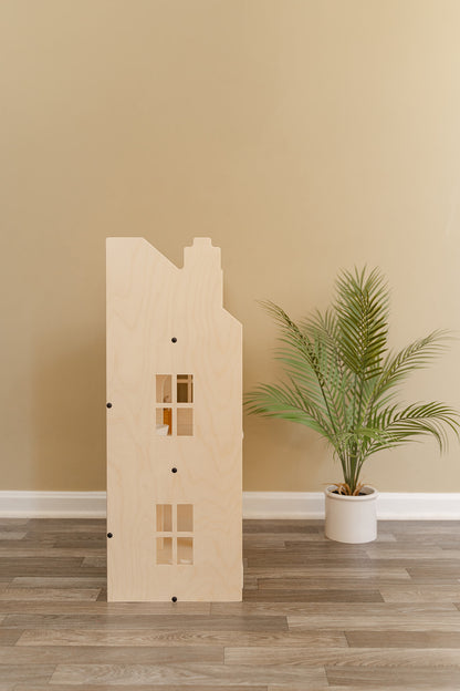 Side profile of Georgian-style wooden dollhouse showing 3-story construction with symmetrical windows and Scandinavian-inspired clean lines, large life-size doll house featuring natural birch plywood finish that complements modern home decor, pretend play furniture piece designed for playroom bedroom or family room blending functionality with timeless aesthetic appeal for years of imaginative play